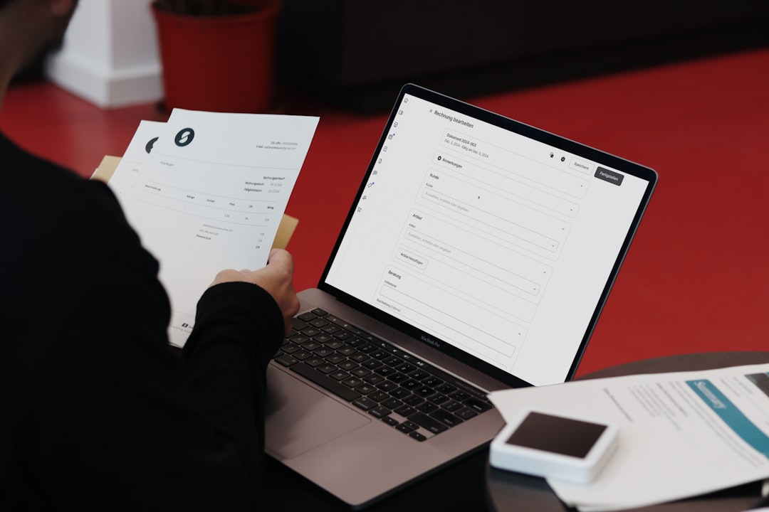 Small business owner reviewing invoices and paperwork at desk